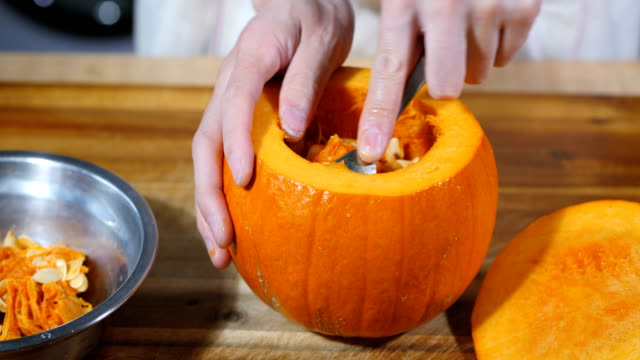 Man carve a pumpkin for halloween party