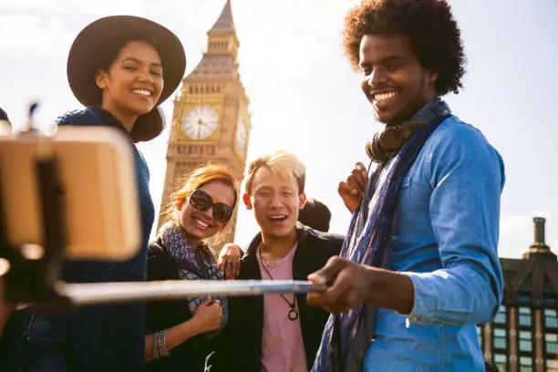 ulti ethnic group of friends taking a selfie with BigBen in Central London