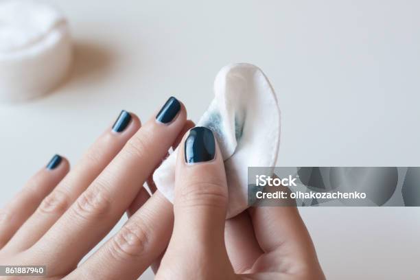 Woman Removes The Nail Polish Dark Blue Manicure Stock Photo - Download Image Now - Nail Polish, Removing, Cotton Pad