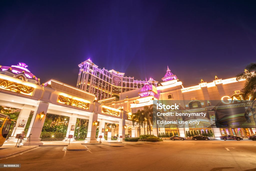 Galaxy Casino in Macau Macau, China - December 8, 2016: Golden shining Galaxy hotel and casino in Cotai Strip of Macau at night. Macau is now gambling capital of Asia and visited by over 25 million people every year. Addiction Stock Photo
