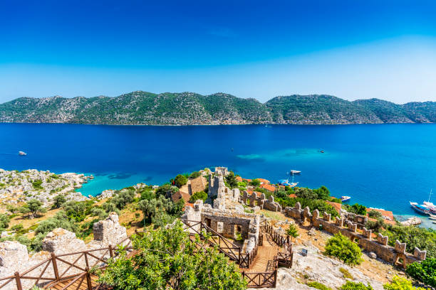 Kalekoy and Simena Ancient City in Turkey Kalekoy this is located on the rocky south coast and the sunken remains of ancient Simena, kekova stock pictures, royalty-free photos & images