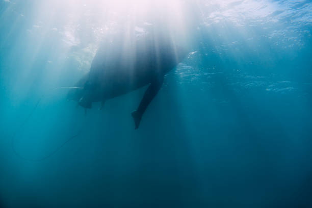 istock Surfer relax on surfboard in underwater. Sun rays in ocean 861899678