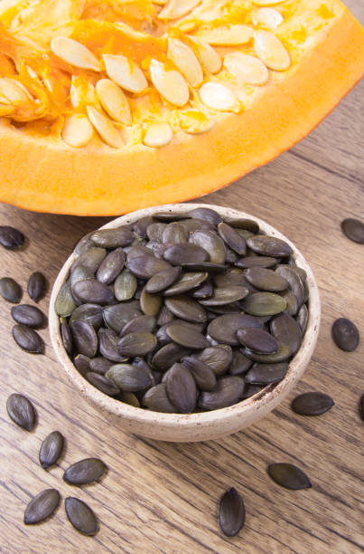 istock Pumpkin seeds on a wooden background. 861900018