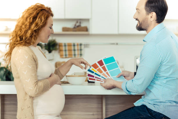 istock Amused family holding papers with colors 861902424