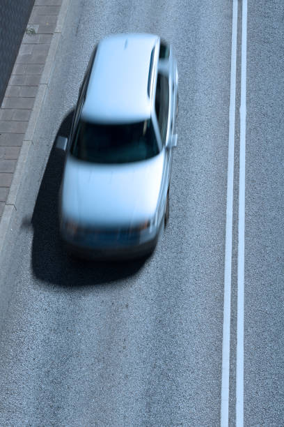 istock Double white lines dividing the lanes, motion blurred car 861915004