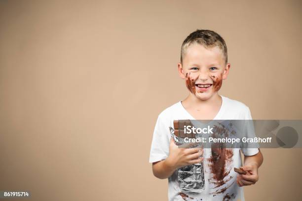 Little Boy Holds A Bar Of Chocolate In His Hand Stock Photo - Download Image Now - Chocolate, Child, Stained