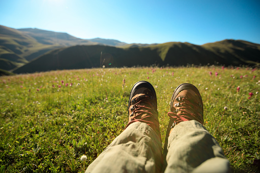 hiker legs hiking in grassland mountains top