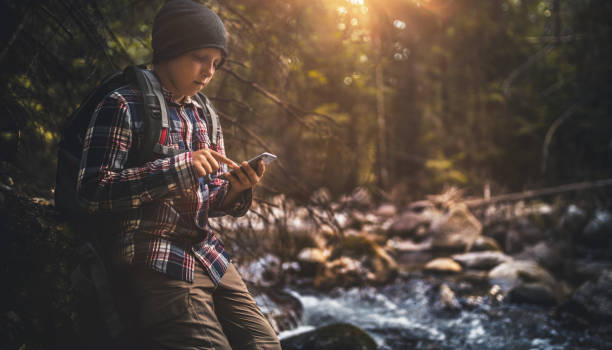istock Young traveler using smartphone in the forest 861919540