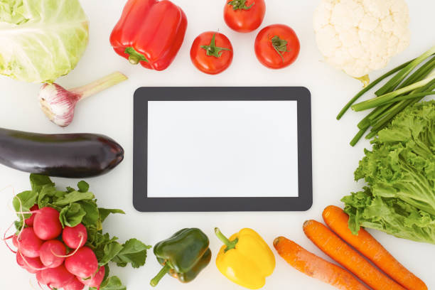 istock Close up of diet plan on tablet pc screen and vegetables. 861920102
