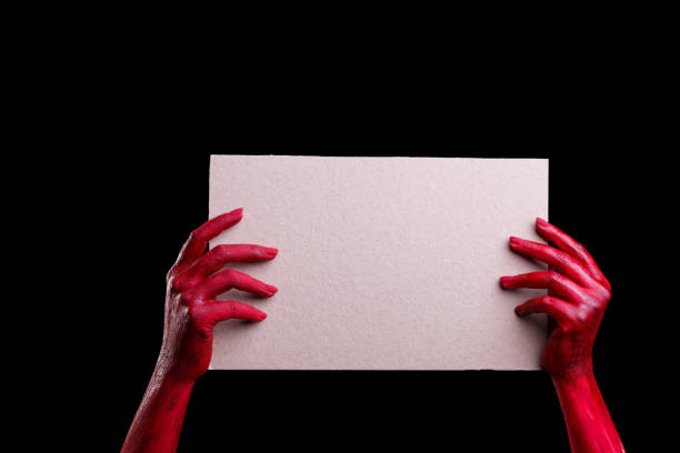 istock Human hands painted in red are posing on a black background. 861934756