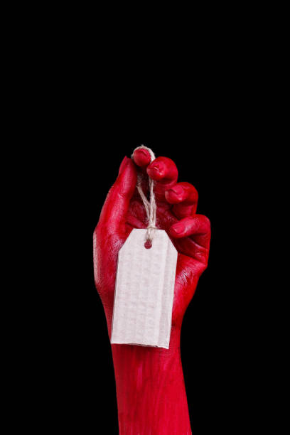 istock Human hands painted in red are posing on a black background. 861934928