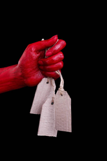 istock Human hands painted in red are posing on a black background. 861935070
