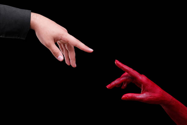istock Human hands painted in red are posing on a black background. 861935296
