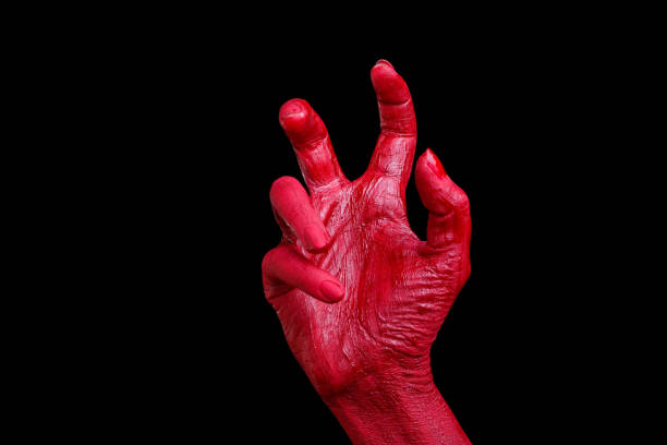 istock Human hands painted in red are posing on a black background. 861935364