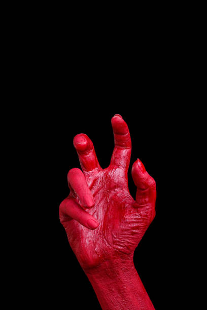 istock Human hands painted in red are posing on a black background. 861935394