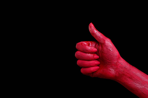 istock Human hands painted in red are posing on a black background. 861936572
