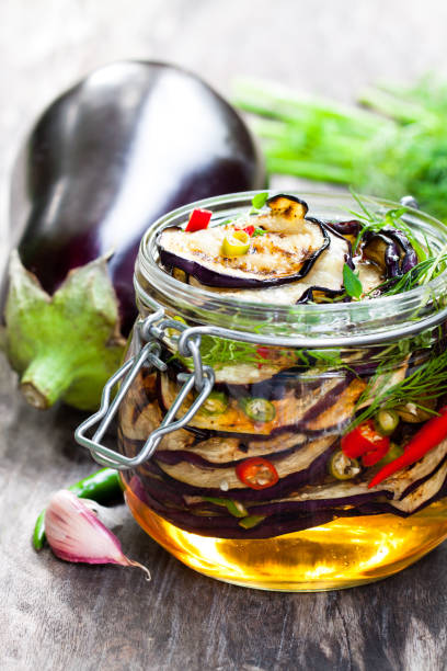 istock Grilled  sliced eggplant with chili in glass jar on rustic table. 861938210