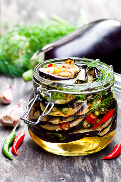istock Grilled  sliced eggplant with chili in glass jar on rustic table. 861938554