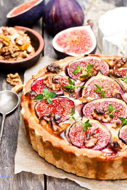 istock Delicious  tart with fresh figs and goat cheese on rustic wooden table 861939342