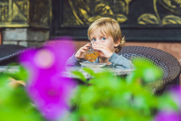 istock Cute little boy drinking tea in cafeteria 861939876