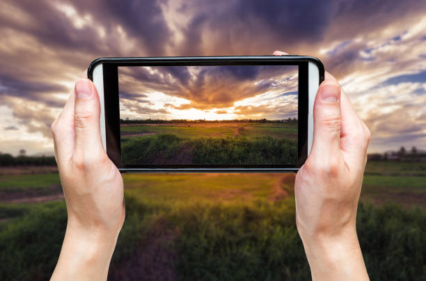 istock hand woman taking photo at sunset. 861947400