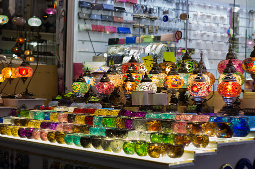 Amazing traditional handmade turkish lamps in souvenir shop. Mosaic of colored glass. Lit in the evening, creating a cozy atmosphere