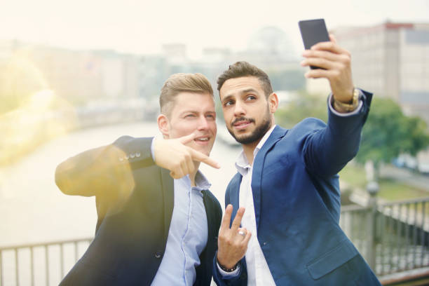 istock two handsome businessmen talking a selfie 861954978