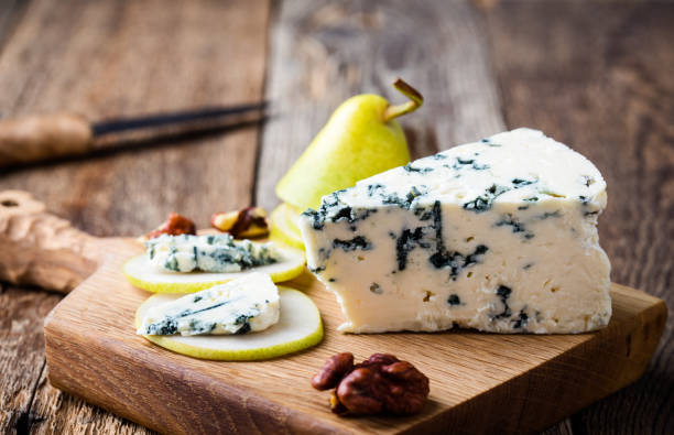 Blue cheese with fresh pear Cheese platter. Blue cheese with fresh pear on rustic wooden board blue cheese stock pictures, royalty-free photos & images