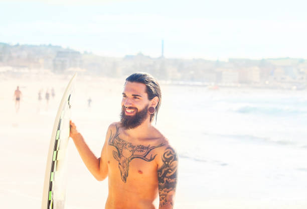istock Surfer holding his surfboard at the beach, Bondi Beach 861966858