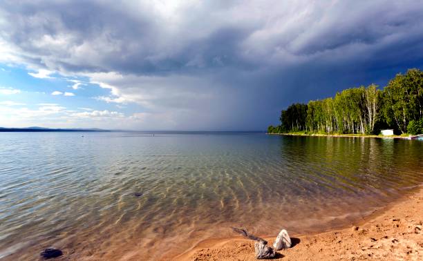 istock dark storm clouds before rain above the lake 861970262
