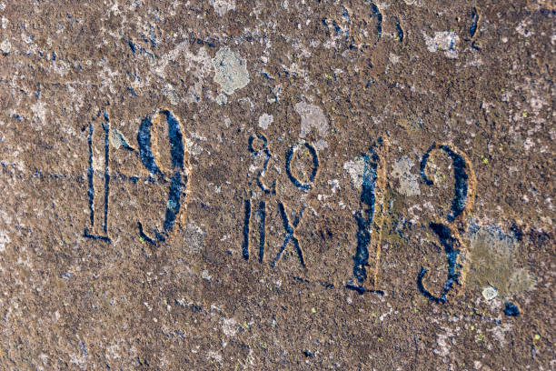 istock Old half-erased inscriptions, embossed on a granite rock. 861970316