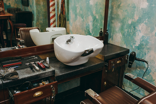 The workplace with a washbasin in barbershop. Interior of luxury beauty salon.