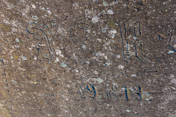 Old half-erased inscriptions, embossed on a granite rock.