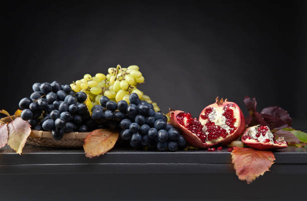 istock blue and green grapes with pomegranate 861975384