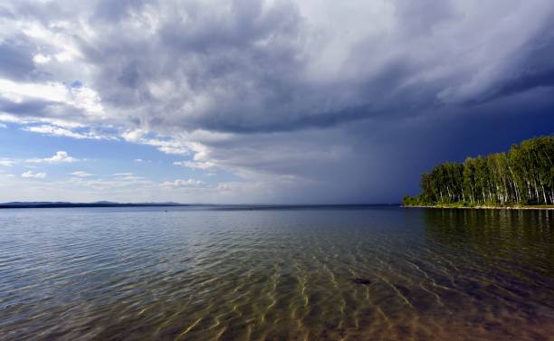 istock dark storm clouds before rain above the lake 861975556