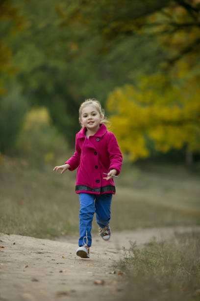 istock Little girl run on footpath 861975934