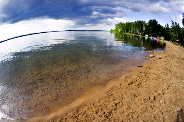 istock dark storm clouds before rain above the lake 861978800