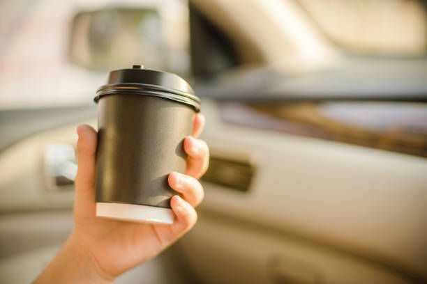 istock hand holding coffee cup in car 861983374