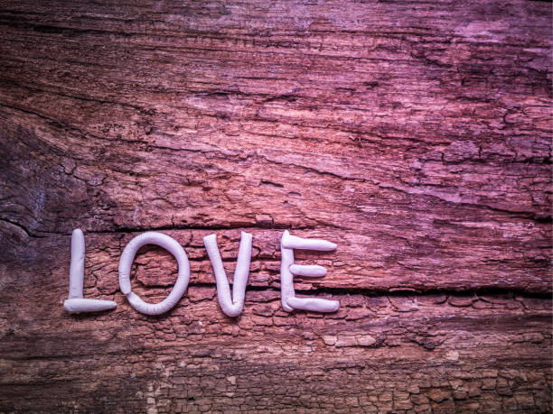 istock Love wording mold by clay on rough wood background 861987204