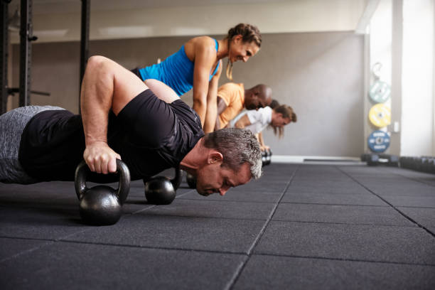istock People doing pushups together in a health club class 861987308