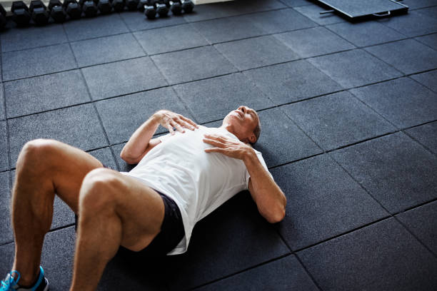 istock Exhausted man lying on a gym floor after working out 861988002