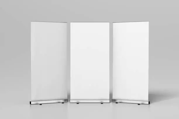 Three blank roll up banner stands isolated on white. Include clipping paths around ad banners. 3d illustration
