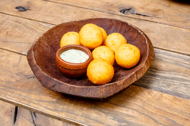 istock Cheese balls breaded lie on a wooden plate. 862003048