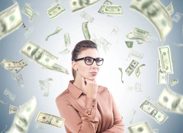 istock Pensive woman in beige, dollar rain 862010252