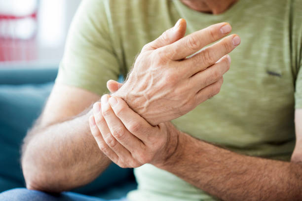 Old man suffering from pain and rheumatism stock photo