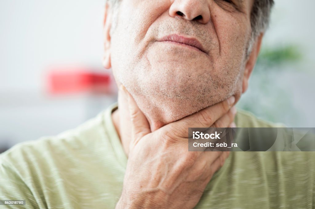 Old man feeling painful in the throat Physical Injury Stock Photo