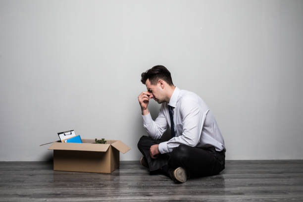 istock Fired frustrated man in suit sitting on floor in office. Sad 862021236