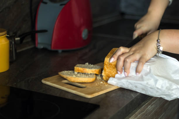 istock woman cutting white bresd 862022450