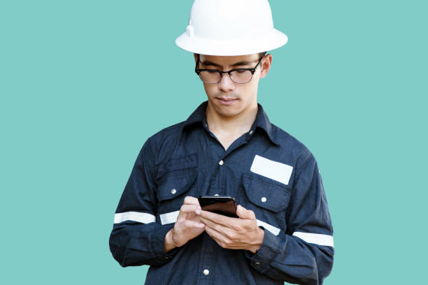 istock Asian man,Engineer or Technician in white helmet, glasses and blue working shirt suit using smart phone, isolated on green, mechanic and Oil and Gas industrial concept with clipping path. 862022808