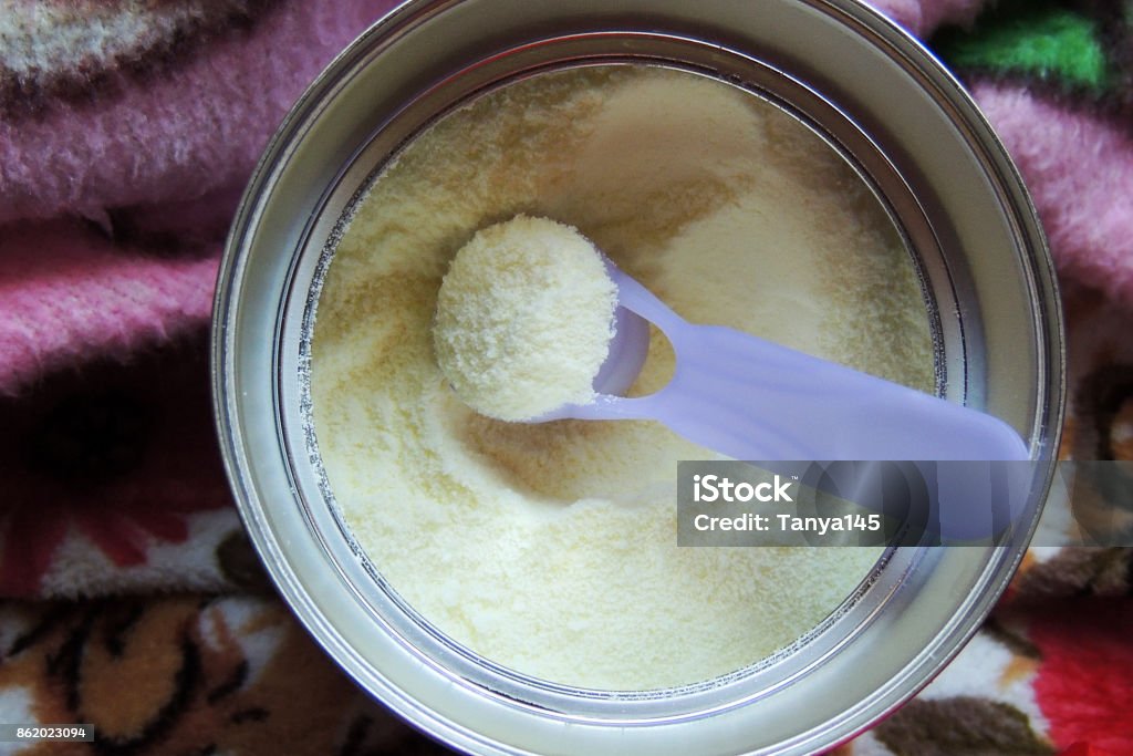 Baby food. Powdered milk Baby Milk Formula with plastic measuring spoon. With Clipping Path. Mathematical Formula Stock Photo